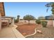 Large backyard with desert landscaping offering a covered patio area for outdoor relaxation and entertaining at 3831 Flickering Star Dr, Las Vegas, NV 89103