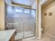 Bathroom features a glass enclosed shower and toilet with beige tile floor at 3831 Flickering Star Dr, Las Vegas, NV 89103