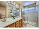 Bathroom features a double sink vanity, and a glass enclosed shower for a luxurious feel at 3831 Flickering Star Dr, Las Vegas, NV 89103