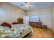 Comfortable bedroom features a floral comforter and hardwood floors, creating a warm and inviting space at 3831 Flickering Star Dr, Las Vegas, NV 89103