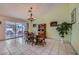 Bright dining room with tiled floors and backyard views through the sliding glass door at 3831 Flickering Star Dr, Las Vegas, NV 89103