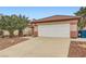 Lovely home featuring a two-car garage, desert landscaping, and a charming front exterior with a red tile roof at 3831 Flickering Star Dr, Las Vegas, NV 89103
