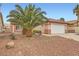 Attractive home featuring a front yard with desert landscaping, a two-car garage, and a red-tiled roof at 3831 Flickering Star Dr, Las Vegas, NV 89103