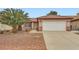Charming single-story home featuring a well-maintained front yard and a two-car garage with a red tile roof at 3831 Flickering Star Dr, Las Vegas, NV 89103