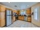 Modern kitchen with stainless steel appliances, tiled floors and oak cabinets at 3831 Flickering Star Dr, Las Vegas, NV 89103