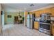 Modern kitchen with stainless steel appliances, tiled floors, and adjacent dining area at 3831 Flickering Star Dr, Las Vegas, NV 89103