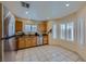 Well-lit kitchen with wood cabinets, stainless steel appliances, and tile flooring at 3831 Flickering Star Dr, Las Vegas, NV 89103