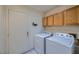 The laundry room is equipped with a washer and dryer, and wood cabinets at 3831 Flickering Star Dr, Las Vegas, NV 89103