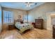 Comfortable bedroom featuring hardwood floors, a ceiling fan, and ample natural light at 3831 Flickering Star Dr, Las Vegas, NV 89103