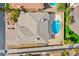 Aerial shot of a house with a gray roof and a kidney-shaped pool with a spa in the backyard at 4372 Melrose Abbey Pl, Las Vegas, NV 89141