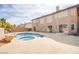 Spacious backyard featuring a pool, hot tub, and a multi-story house with multiple sliding glass doors at 4372 Melrose Abbey Pl, Las Vegas, NV 89141