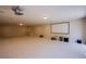 Expansive basement features carpeting, recessed lighting, and plenty of space for activities at 4372 Melrose Abbey Pl, Las Vegas, NV 89141