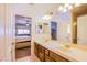 Bathroom with double sinks and large mirrors, offering a glimpse into a bedroom for convenience at 4372 Melrose Abbey Pl, Las Vegas, NV 89141