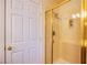 Bathroom with a gold framed glass shower showcasing the neutral colored tile at 4372 Melrose Abbey Pl, Las Vegas, NV 89141