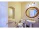 Charming powder room featuring a pedestal sink, toilet, and decorative mirror at 4372 Melrose Abbey Pl, Las Vegas, NV 89141