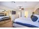 Bright bedroom with sliding mirror closet doors, TV, ceiling fan, and views through adjacent doorway at 4372 Melrose Abbey Pl, Las Vegas, NV 89141
