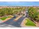 An impressive gated community entrance with lush landscaping, palm trees, and a beautiful entryway structure at 4372 Melrose Abbey Pl, Las Vegas, NV 89141