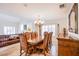 Formal dining room featuring a large wooden table and elegant chandelier at 4372 Melrose Abbey Pl, Las Vegas, NV 89141