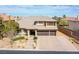 Elegant two-story home featuring a three-car garage, stone accents, and meticulously landscaped front yard at 4372 Melrose Abbey Pl, Las Vegas, NV 89141