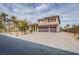 Luxury home with a three-car garage, brick driveway, and landscaped front yard at 4372 Melrose Abbey Pl, Las Vegas, NV 89141