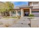 Beautiful home showcasing a stone facade, manicured landscaping, and a welcoming front entrance with columns at 4372 Melrose Abbey Pl, Las Vegas, NV 89141