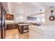 Gourmet kitchen featuring dark wood cabinetry, granite countertops, and center island at 4372 Melrose Abbey Pl, Las Vegas, NV 89141