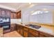 Kitchen with granite countertops, dark wood cabinets, and stainless steel cooktop at 4372 Melrose Abbey Pl, Las Vegas, NV 89141