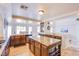 Modern kitchen with granite countertops, dark wood cabinets, and stainless steel appliances at 4372 Melrose Abbey Pl, Las Vegas, NV 89141