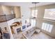 Aerial view of living room with fireplace open to the wet bar and kitchen area with seating at 4372 Melrose Abbey Pl, Las Vegas, NV 89141