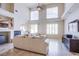 Bright living room with tall ceilings, tile flooring, large windows and modern decor at 4372 Melrose Abbey Pl, Las Vegas, NV 89141