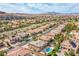 A well-maintained residential neighborhood featuring a variety of homes, mature trees, and mountain views at 4372 Melrose Abbey Pl, Las Vegas, NV 89141