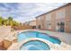 Inviting backyard oasis features a sparkling pool, spa, and patio for relaxing and entertaining at 4372 Melrose Abbey Pl, Las Vegas, NV 89141