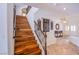 Beautiful wooden staircase with wrought iron railing and decorative wall art at 4372 Melrose Abbey Pl, Las Vegas, NV 89141