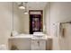 Modern bathroom features pendant lighting over floating vanity with vessel sink and large mirror at 4381 W Flamingo Rd # 3002, Las Vegas, NV 89103