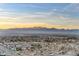 Expansive view featuring mountains and the city extending into the distance under a blue and orange sky at 4381 W Flamingo Rd # 3002, Las Vegas, NV 89103