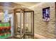 Elegant entrance featuring a revolving door and decorative stone wall with a promotional poster at 4381 W Flamingo Rd # 3002, Las Vegas, NV 89103
