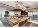 Elegant kitchen with stainless steel appliances, island with bar seating, and a view to the living area at 4381 W Flamingo Rd # 3002, Las Vegas, NV 89103