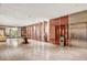 Wide view of modern lobby area with tiled floors, plants, elevators, and a seating area at 4381 W Flamingo Rd # 3002, Las Vegas, NV 89103