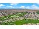 Panoramic aerial view of a community with a scenic golf course, lush greenery, and well-maintained residential areas at 508 Via Palermo Dr, Henderson, NV 89011