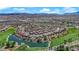 Scenic aerial view of a community, highlighting the lush green golf course, sparkling pond, and neatly arranged homes at 508 Via Palermo Dr, Henderson, NV 89011