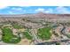 Breathtaking aerial view of a community with a sprawling golf course winding through meticulously landscaped neighborhoods at 508 Via Palermo Dr, Henderson, NV 89011
