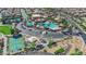 Aerial view of a community clubhouse featuring swimming pools, sports courts, and a playground for recreational activities at 508 Via Palermo Dr, Henderson, NV 89011