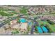Aerial view of a community clubhouse with multiple pools, tennis courts, and green spaces for outdoor enjoyment at 508 Via Palermo Dr, Henderson, NV 89011