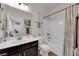Bright bathroom features a single sink vanity with framed mirror and tub with shower at 508 Via Palermo Dr, Henderson, NV 89011