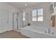 Bright bathroom with a large soaking tub, walk-in shower, and white tiled walls at 508 Via Palermo Dr, Henderson, NV 89011