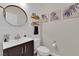 Stylish powder room with a modern vanity, round mirror, and shiplap wall accent at 508 Via Palermo Dr, Henderson, NV 89011