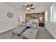 Charming bedroom with a wood accent wall, ceiling fan, and light gray chaise lounges at 508 Via Palermo Dr, Henderson, NV 89011