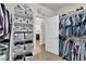 Walk-in closet with built-in shelves, gray bins, and access door to the bathroom at 508 Via Palermo Dr, Henderson, NV 89011