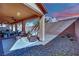 Spacious covered patio with brick flooring, stylish outdoor furniture, and a well-maintained landscape at 508 Via Palermo Dr, Henderson, NV 89011