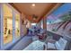 Cozy covered patio featuring brick flooring, comfortable seating, ceiling fans, and access to the home's interior at 508 Via Palermo Dr, Henderson, NV 89011
